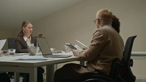Male Manager in Wheelchair Solving Problems at Board Meeting in Office Stock Footage 309045877