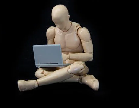 Male mannequin sitting with laptop studying or working from home Stock Photos