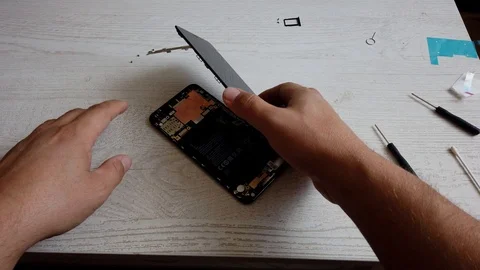 Male master disassembling smart phone for change broken details Repairer work Stock Footage 124746144