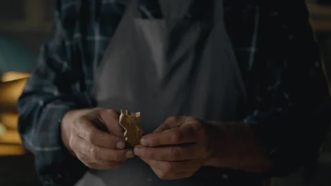 A male master making chess pieces to order performs chess pieces while in a Stock Footage 269241572