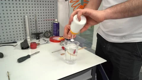 Male master making liquid solution while assembling prosthesis Stock Footage 236621168