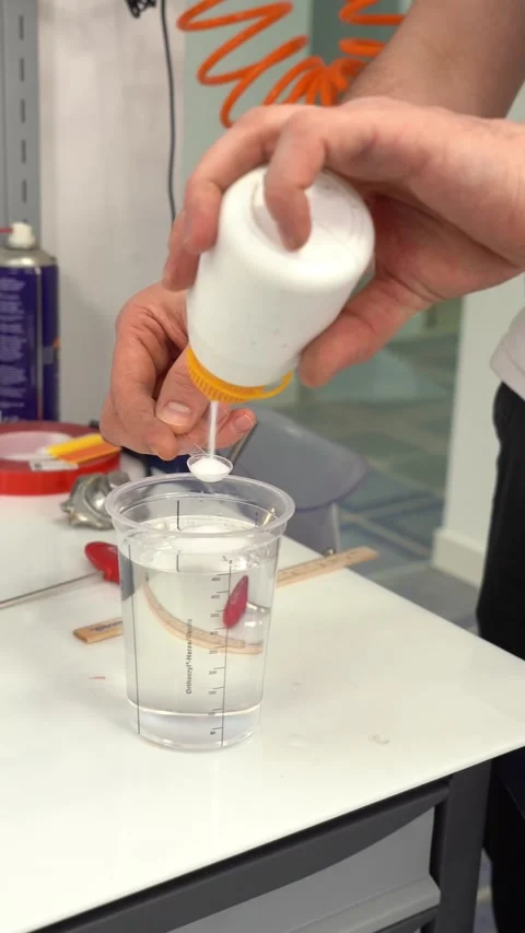 Male master making liquid solution while assembling prosthesis. Vertical video Stock Footage 237605959