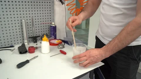 Male master mixing liquid solution while assembling prosthesis Stock Footage 236621289