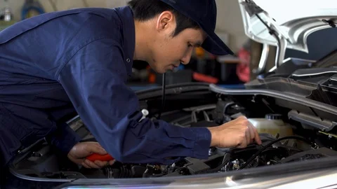 Male mechanic checking a car engine problem Stock Footage 124938661