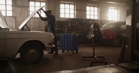 Male mechanic checking engine of car Stock Footage 221107467