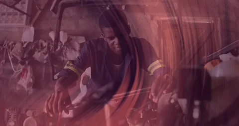 Male mechanic leaning over engine in auto workshop, displaying animated wrench Video stock 330288279
