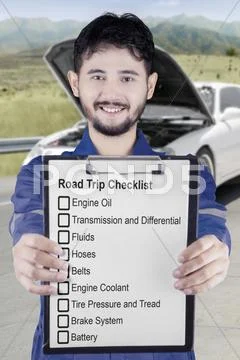 Male mechanic shows road trip tips Stock Photos