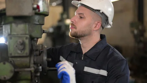 Male mechanical engineer repairing engine machine at factory Video stock 237625088
