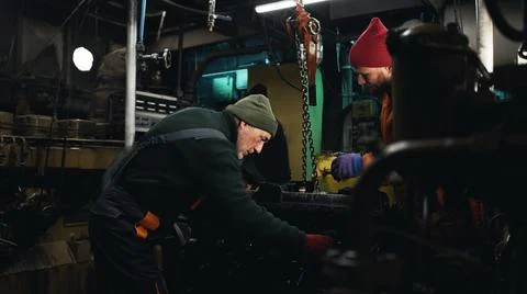 Male mechanics assembling engine on ship 写真素材