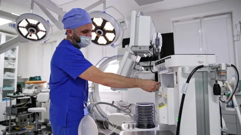 Male medic working in the empty modern well equipped surgery room.  Stock Footage 229870265