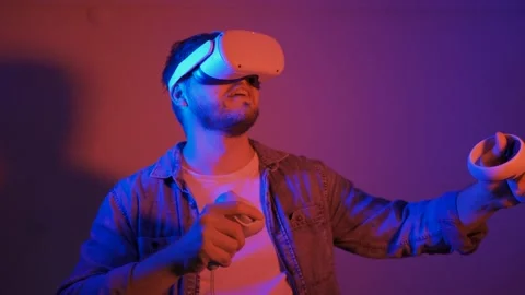 Male men using VR headset, playing video games on neon background Stock Footage 171176361