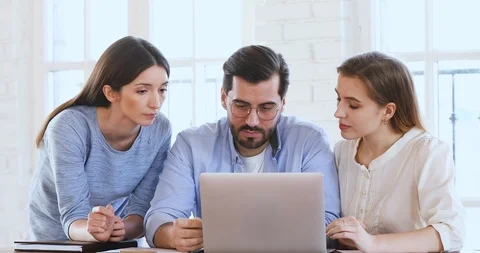 Male mentor explaining web design project data teach female interns Stock Footage 125125661