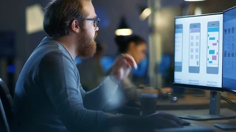 Male Mobile Application Developer Works with Graphics on His Personal Computer. Stock Footage 79396996