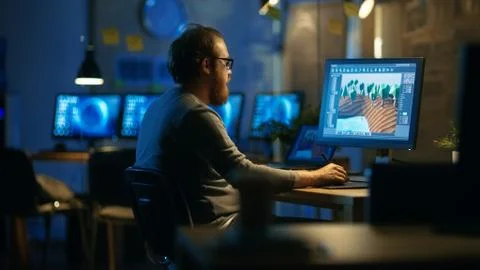 Male Mobile Application Developer Works with Graphics on His Personal Compute Stock Photos
