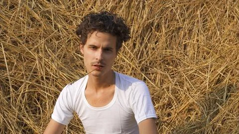 Male model on the background of a haystack Stock Photos