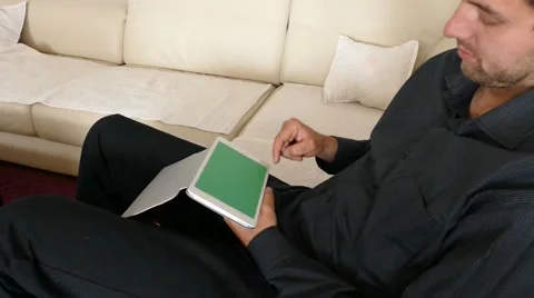 Male Model In Dark Jacket Looking At Ipad - Tablet Technology Internet Search Stock Footage 49217871