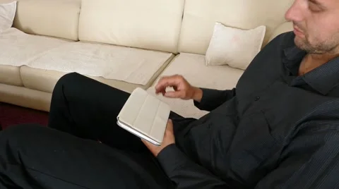 Male Model In Dark Jacket Looking At Ipad - Tablet Technology Internet Search Stock Footage 49218341