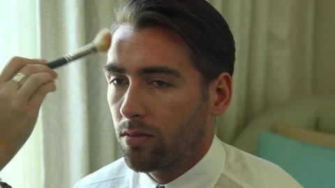 A male model getting his makeup done Stock Footage 132953914