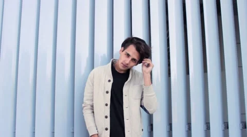 Male model looking into the camera and smiling. The guy attractive and Stock Footage 54684203