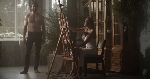 Male model with naked torso posing for artist in workshop Stock Footage 251521574