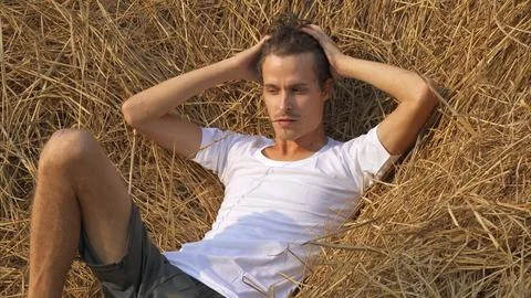Male model posing in a haystack Stock Photos