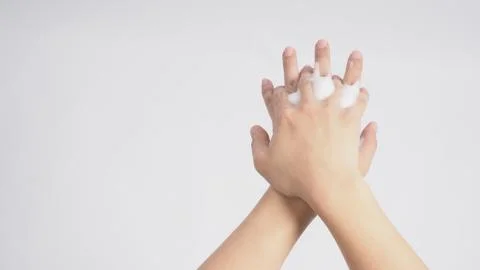 Male model is rub backs of both hands with foaming hand soap on white backgro Stock Photos