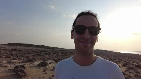 Male model smiling at camera posing in sun on summer day. Stock Footage 242485916