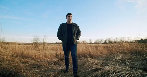 Male Model Walks Passed Camera Into Sunset Stock Footage 122221209
