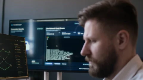 Male Network Engineer Analyzing Cybersecurity Software on Computers in Office 動画素材 334932314