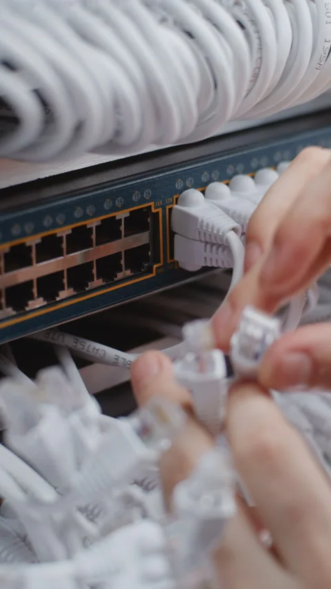 Male Network Specialist Reconfiguring Physical Connections Inside Server Rack Stock Footage 344975178