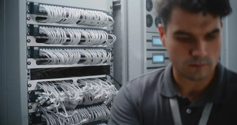 Male Network Technician Installing Managed Switch During Data Center Upgrade 動画素材 344977707