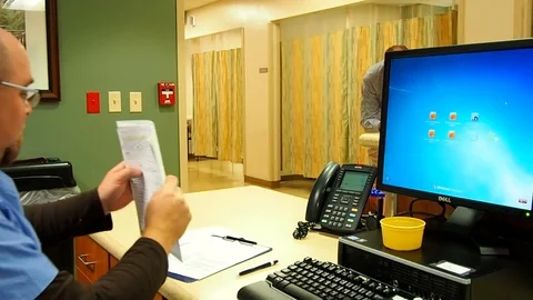 Male nurse doing paperwork Stock Footage 70686959