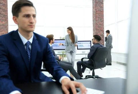 A male office worker browsing the computer for information Stock Photos