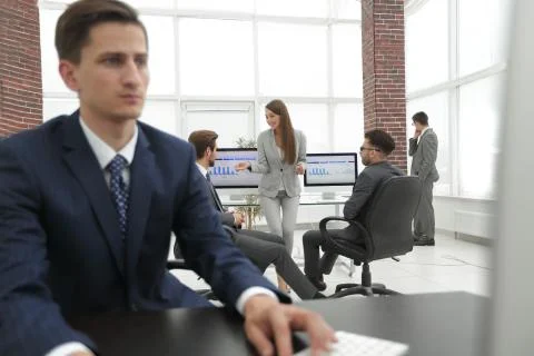 A male office worker browsing the computer for information 写真素材