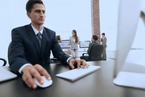 A male office worker browsing the computer for information Stock Photos