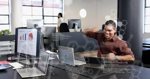 Male office worker coding laptop, cheering after success while hex code overlays Stock Footage 321763681