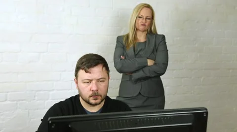 Male office worker at computer with attractive female boss watching business Stock Footage 47815730
