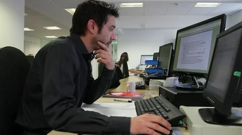 Male Office Worker On Computer - Dolly Shot Stock Footage