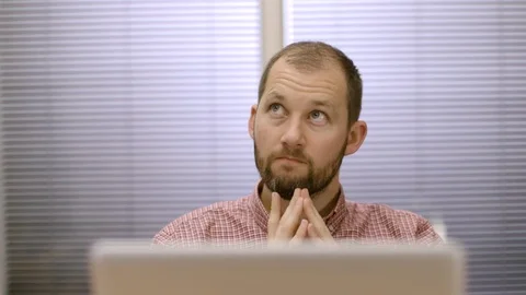 Male office worker thinking of an idea at his desk with laptop computer 스톡 동영상 73122719