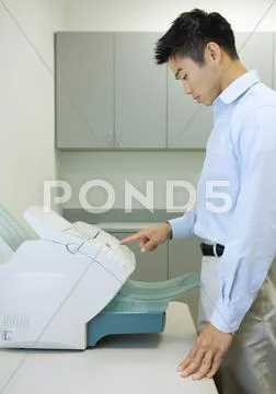 Male Office Worker Using Fax Machine