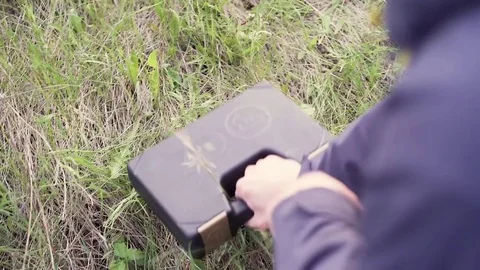 Male opening box-case and reloading a gun on a field shooting Stock-Footage 75891913