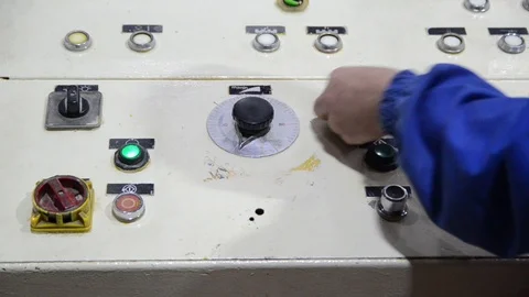 Male operator in front of machine operating console in factory. Line technician Stock Footage 127196627