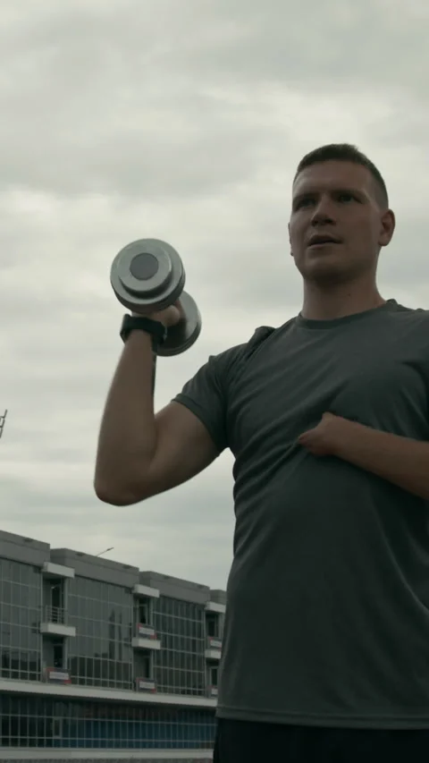 Male Para Athlete with Limb Difference Performing Dumbbell Shoulder Press Video stock 299115568