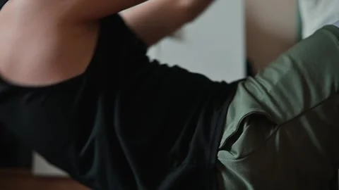 A male participant performs various upper body exercises in a home environment. Stock Footage 339096002