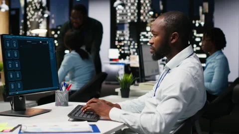 Male PC user interacting with AI chat system on computer at office after hours Stock Footage 318565415