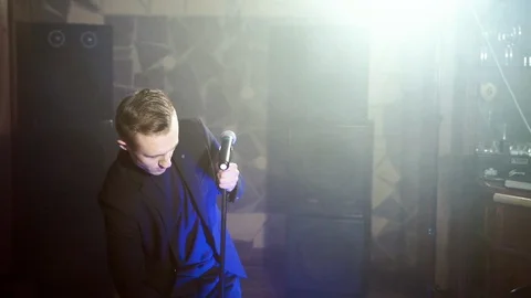 Male performer setting microphone, getting ready for rehearsal. Stock Footage 107697965