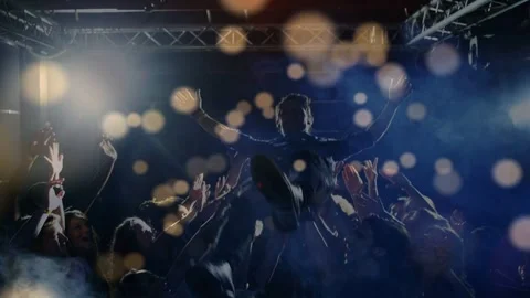Male performer stepping into crowd engaging fans spurring crowd carrying him Stock Footage 333477730