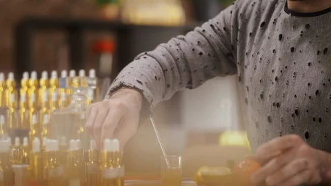 Male perfumer smelling orange selecting scents for his new perfume Stock-Footage 105038153