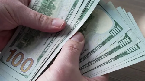 A male person is counting a stack of US dollars. Stock Footage 274868639