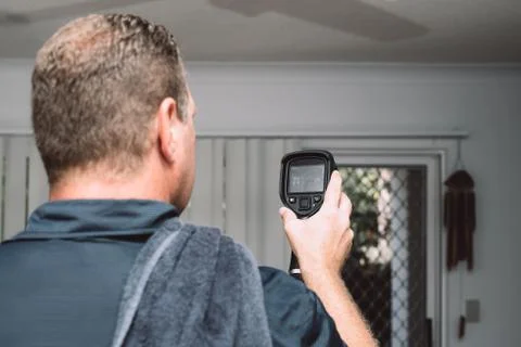 Male Pest Control Worker checking apartment with thermal imaging camera for Stock Photos